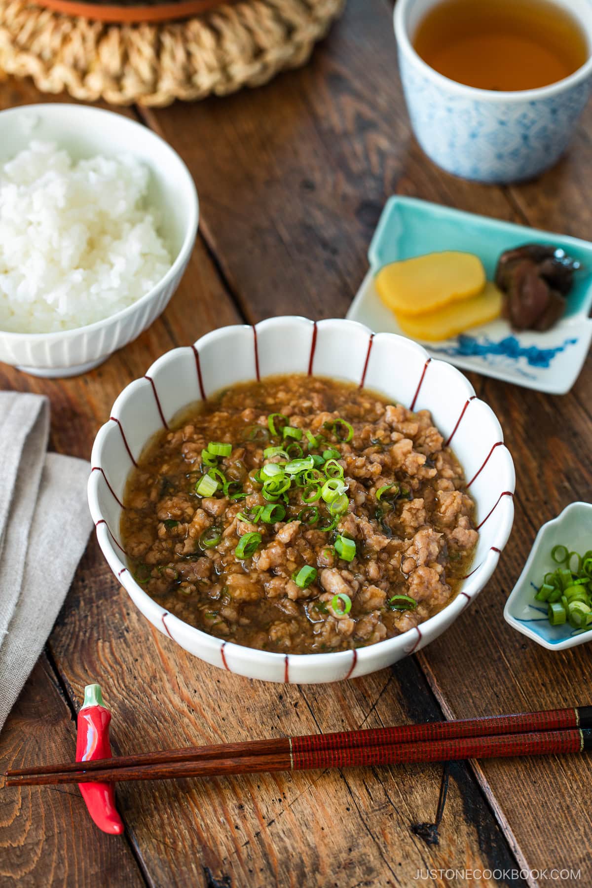 A round bowl containing Niku Miso, a savory Japanese ground pork dish seasoned with miso, mirin, and aromatics.