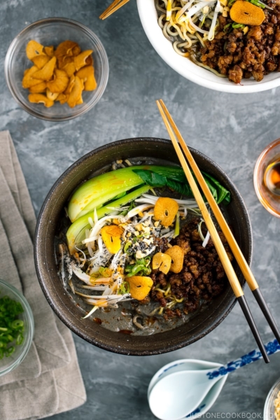 A black bowl containing Black Sesame Dan Dan Noodles.