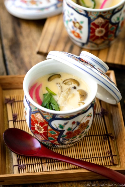 A special Japanese chawanmushi cup containing savory steamed custard filled with kamaboko fish cake, chicken, and mushroom.