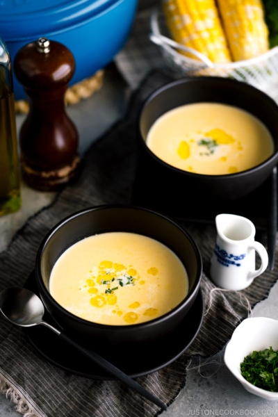 Black bowls containing Japanese corn potage.