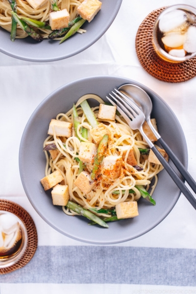 A grey bowl containing Creamy Miso Pasta with Tofu and Asparagus.