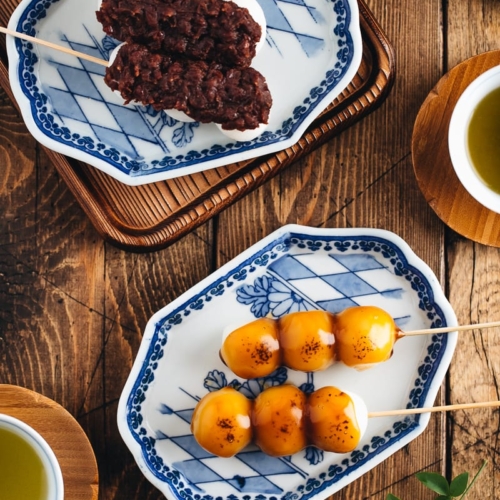 Mitarashi Dango and Dango with anko on a Japanese blue ceramic.