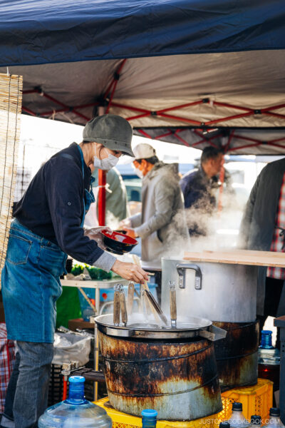 Chef preparing a bowl of noodles