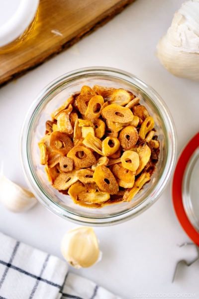 A Weck jar containing golden fried garlic chips.