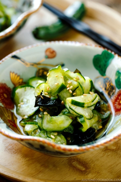 Small Japanese bowls containing Japanese cucumber salad called Sunomono.