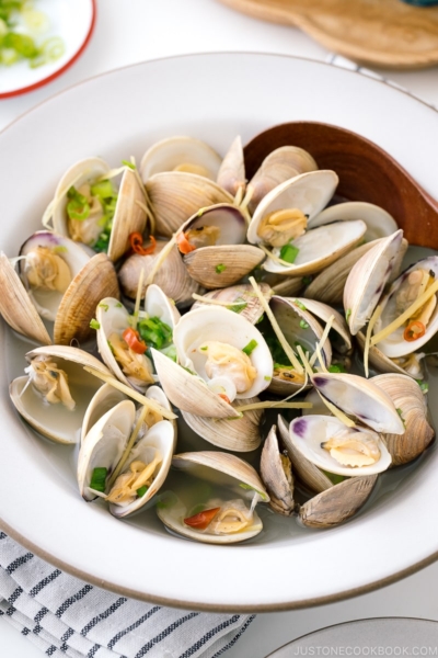 A ceramic bowl containing Japanese Sake-Steamed Clams.