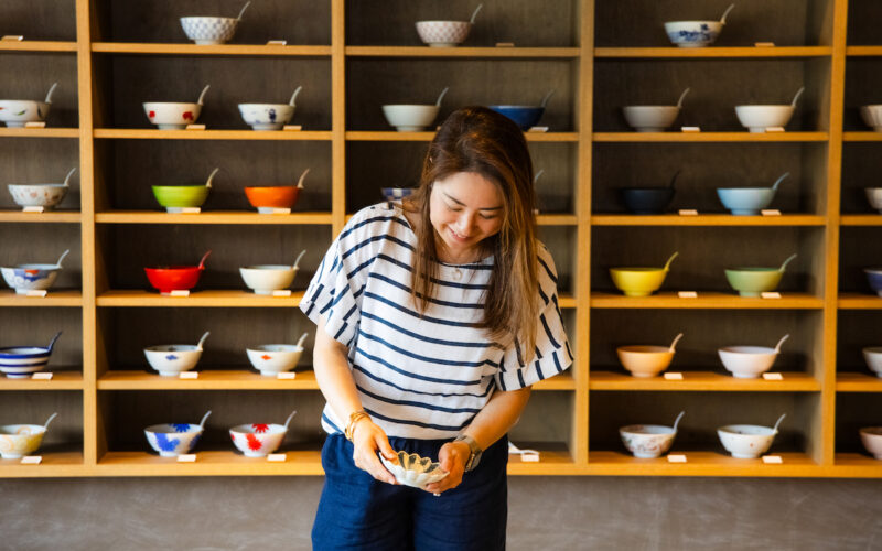 a person holding a tableware in a store