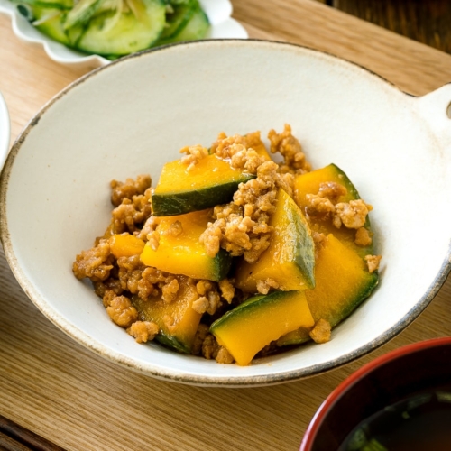 A white ceramic containing Kabocha Pork Stir Fry.