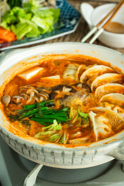 Kimchi Gyoza Nabe served in donabe (Japanese earthenware pot).