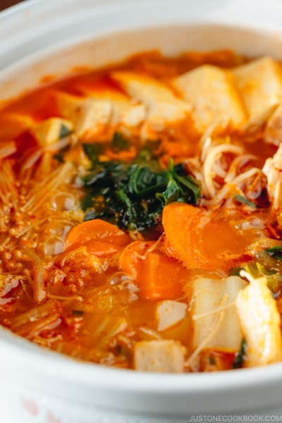 A Japanese donabe containing kimchi stew filled with vegetables and kimchi.