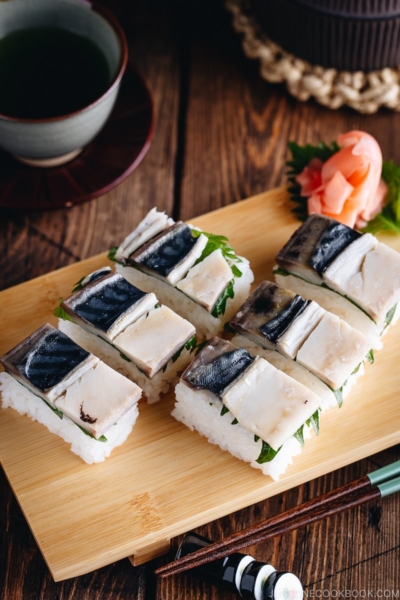 Mackerel Pressed Sushi (Saba Oshizushi) and sushi ginger are on the bamboo sushi tray.