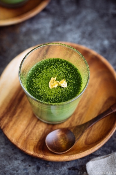 Matcha Vegan Panna Cotta served in a glass bowl, topped with gold flakes!