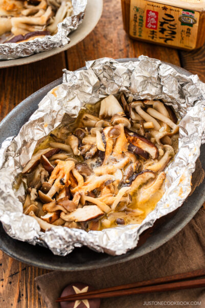 Assortment of mushrooms are wrapped and cooked in foil with miso and butter.