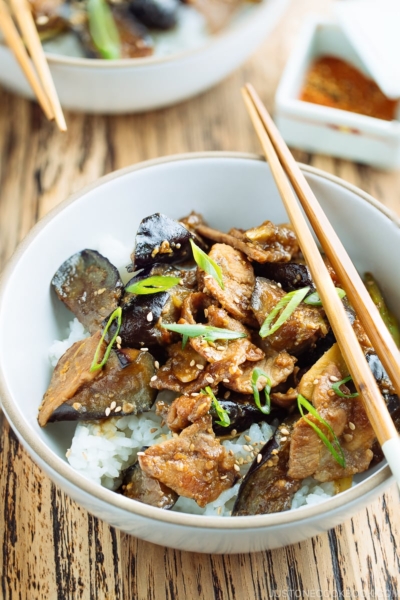 A bowl containing Miso Pork and Eggplant Stir-Fry over steamed rice.