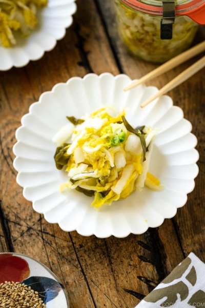 A white ceramic plate containing Napa Cabbage Pickles (Tsukemono).