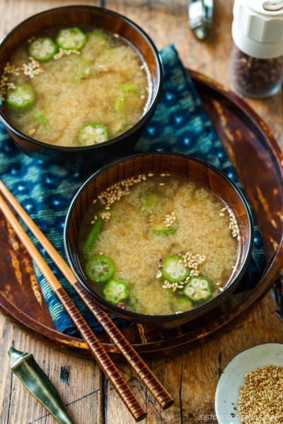 Miso soup bowls containing Natto and Okra Miso Soup topped with sesame seeds.