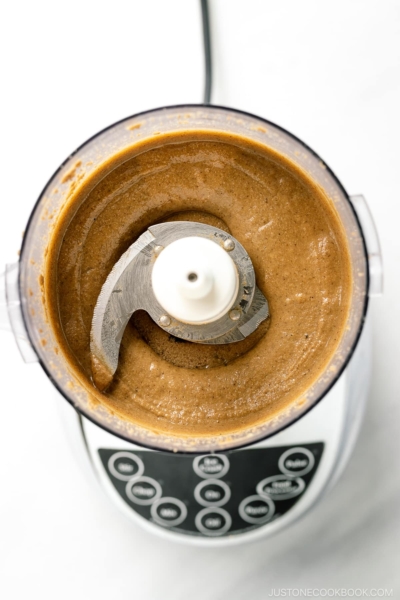 A food processor containing freshly ground Nerigoma (Japanese white sesame paste).