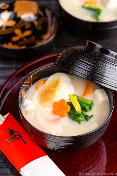 A black and gold lacquered bowl containing Japanese New Year Soup Ozoni.