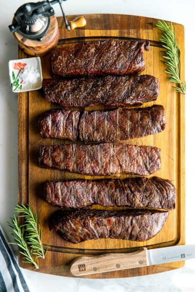 steaks reverse seared to medium rare, medium, and medium well on Traeger on top of wood cutting board