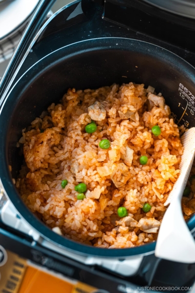 A rice cooker containing Chicken Rice, seasoned with Japanese ketchup and Worcestershire sauce.