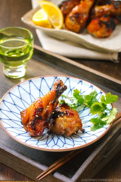 A blue and white plate containing Sweet and Spicy BBQ Chicken Wings.