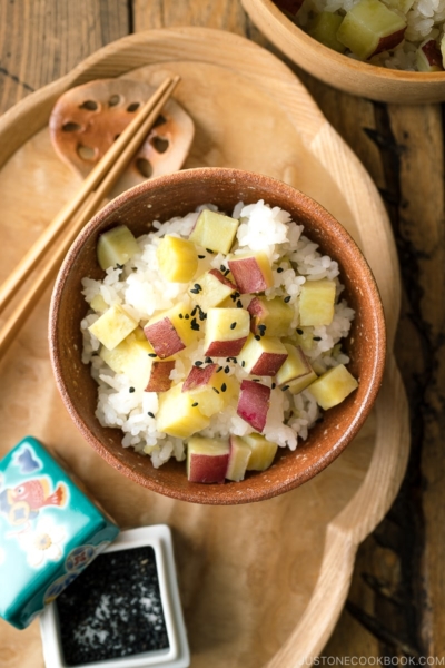 A rice bowl containing Sweet Potato Rice (Satsumaimo Gohan) sprinkled with gomashio (salt & black sesame seeds).