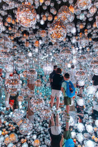 Room filled with hanging glass spheres reflecting LED lights