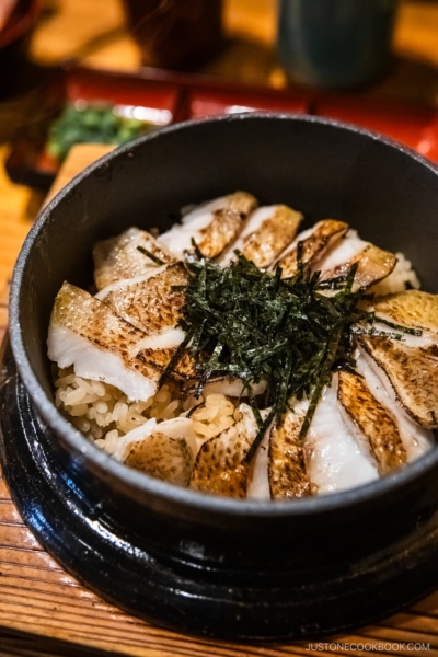 Nodoguro fish on top of rice served in iron pot