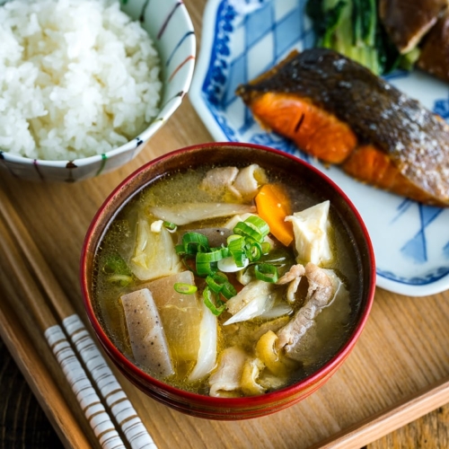 Tonjiru (Pork and Vegetable Soup) served with grilled salmon, steamed rice, and vegetable side dishes.