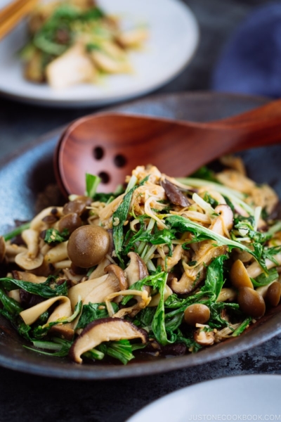 Warm Mushroom Salad with Sesame Dressing in a dark ceramic bowl.