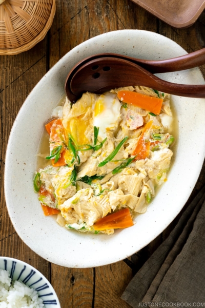 A white ceramic bowl contaiing Yuba Tamagotoji (Simmered Tofu Skin with Soft Scrambled Eggs).